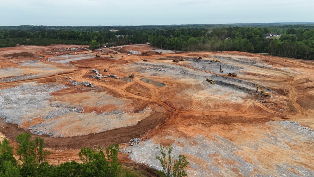 Excavation site with machinery and construction materials.