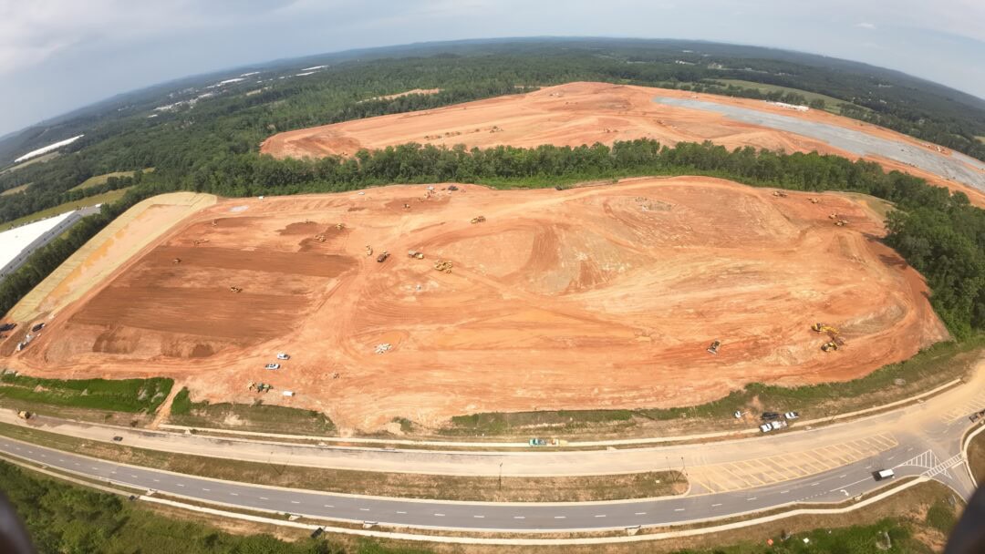 Aerial view of large construction site with equipment.