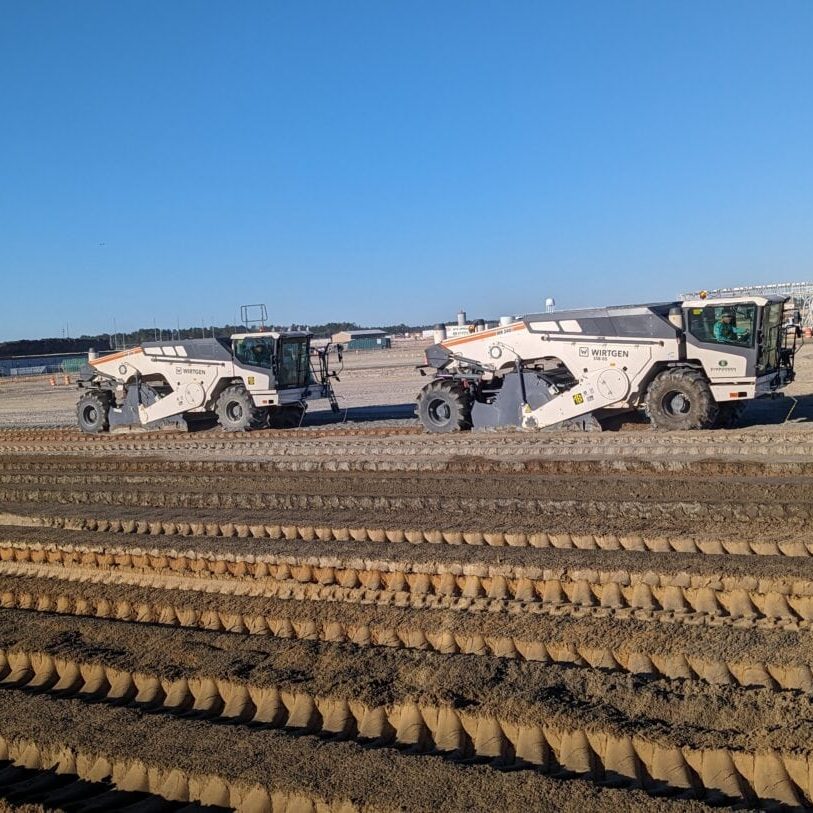 Wide View of Soil Stabilization on Industrial Site Two soil stabilizers operating across large industrial construction site